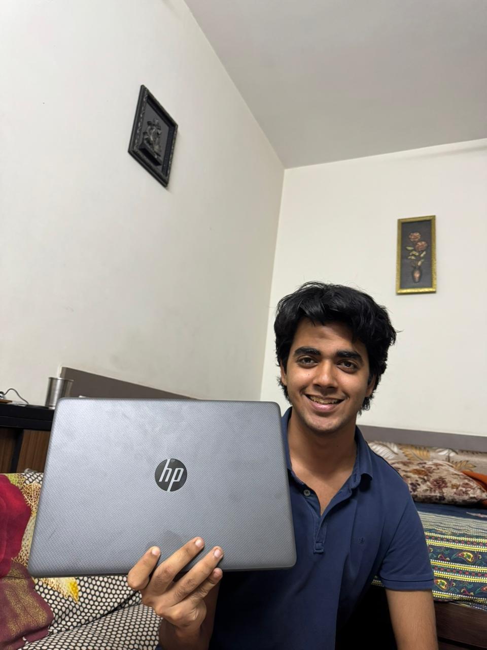 Gantavya Rohilla holding his Aurora prize laptop